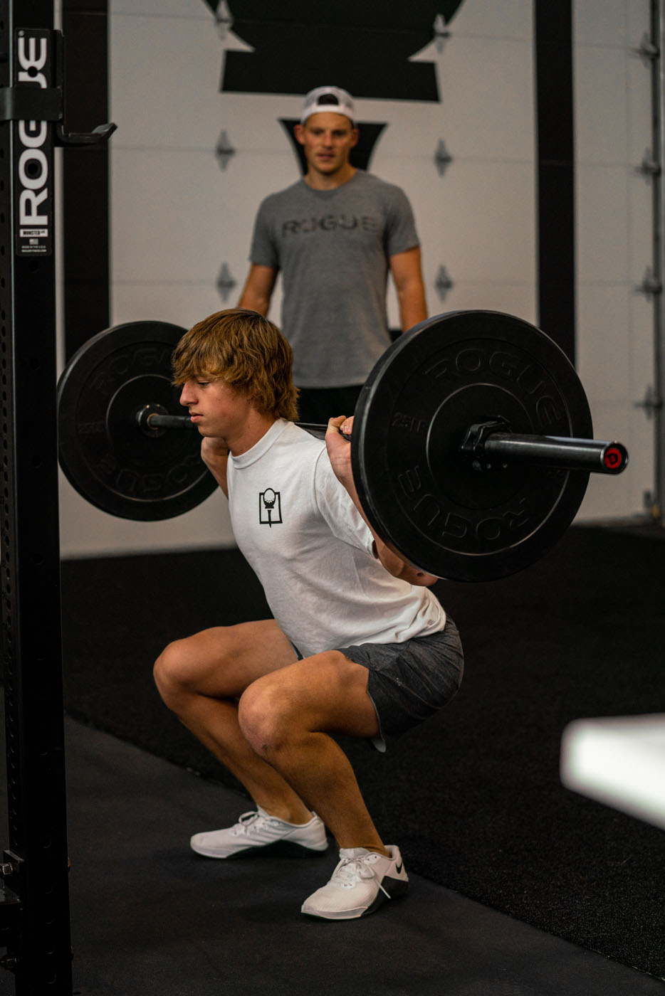 A young adult working out at Tee Box Centerville gym.