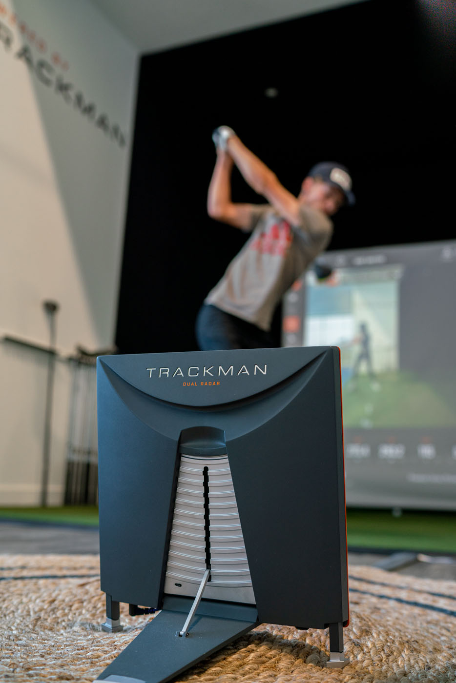 A golfer at Tee Box using our Trackman simulators.